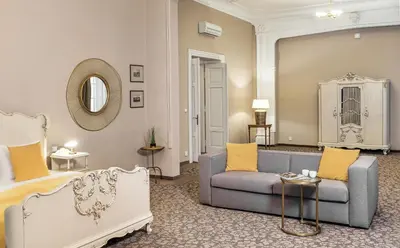 a living room with a couch and a chair at Hotel 