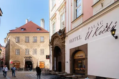 a street in a city with people walking past a store at Hotel 