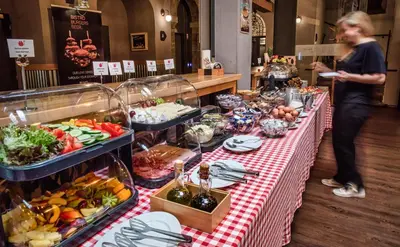a buffet table with a red and white checkered table cloth at Hotel 