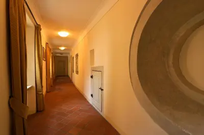 a hallway with a large painting on the wall at Appia Hotel Residences in Prague