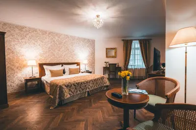 a hotel room with a bed and a table at Appia Hotel Residences in Prague