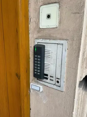 a phone is attached to the side of a wall at Brezina Pension in Prague