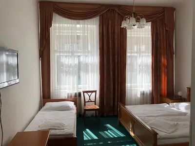 a bedroom with two beds and a window at Brezina Pension in Prague