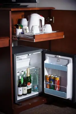 an open refrigerator with bottles and drinks in it at Hotel Petr in Prague