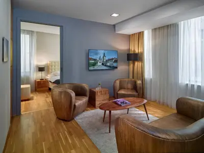 a room with chairs and a table and a bed at The ICON Hotel in Prague