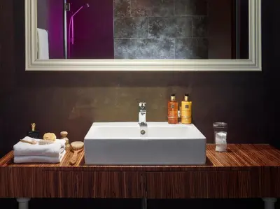 a white sink on a wooden counter in a bathroom at The ICON Hotel in Prague
