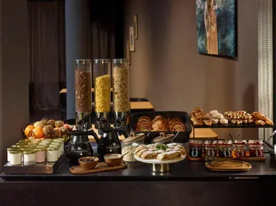 a table topped with different types of bread and pastries at The ICON Hotel in Prague