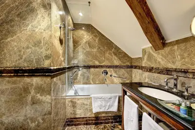 a bathroom with a tub and a sink at The Dominican in Prague