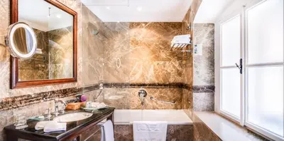 a bathroom with a tub and a sink at The Dominican in Prague