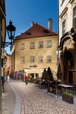 a large building on a street in a city at The Dominican in Prague