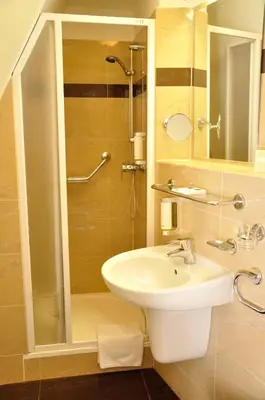 a bathroom with a sink and a shower at Hotel Certovka in Prague