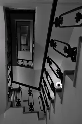 a stairwell with a mirror and a sink at Hotel Certovka in Prague