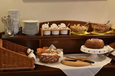 a table with bread and other foods on a shelf at Hotel Certovka in Prague