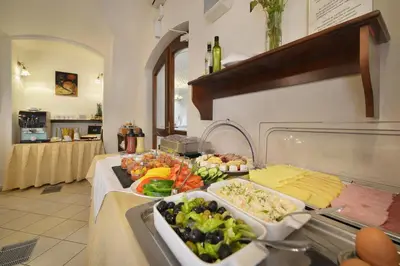 a buffet table with a bunch of food on it at Hotel Certovka in Prague