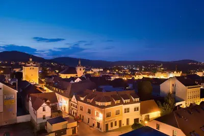 a view of a city at night at Hotel Grand Litava Beroun in Beroun