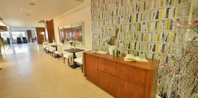 a library with a lot of books on the wall at Hotel Grand Litava Beroun in Beroun