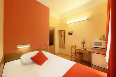 a hotel room with a bed and a microwave at Residence Tabor in Prague