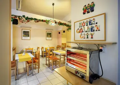 a restaurant with a dining room with tables and a stage at Residence Tabor in Prague