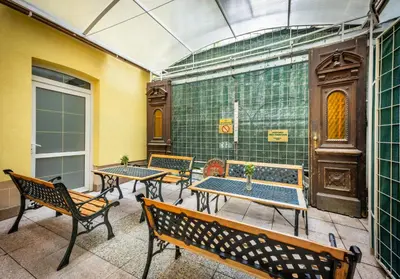 a group of tables and benches on a patio at Residence Tabor in Prague