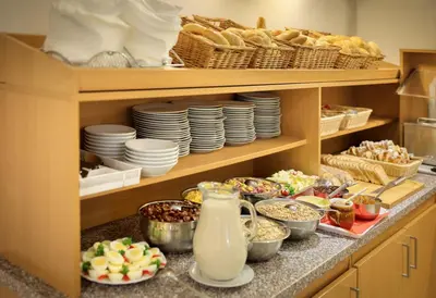a kitchen with plates and bowls of food on a counter at Residence Tabor in Prague