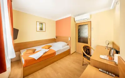 a hotel room with a bed and a desk at Residence Tabor in Prague