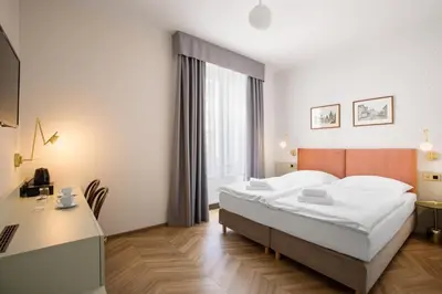 a hotel room with a bed and a desk at Hotel Beránek in Prague