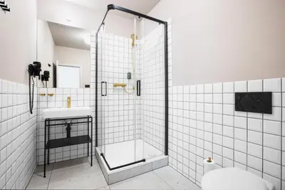 a bathroom with a shower and a sink at Hotel Beránek in Prague