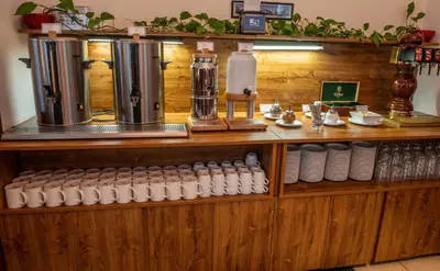 a counter with bottles and cups on a shelf at EA Hotel Sonata in Prague