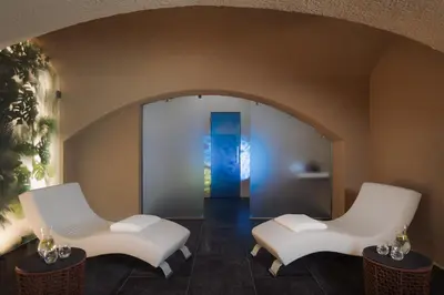 two white chairs in a room with an archway at EA Hotel Sonata in Prague