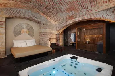 a bedroom with a bed and a bath tub at EA Hotel Sonata in Prague