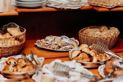 a table with baskets of bread and baskets of pastries at Alton in Prague
