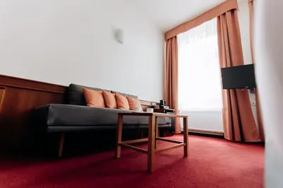 a living room with a couch and a table at Alton in Prague