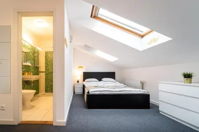 a bedroom with a bed and a bathroom at Little Tom Apartments in Prague