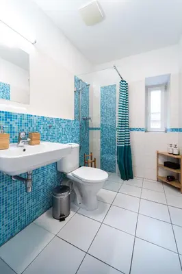 a bathroom with a toilet and a sink and a shower at Little Tom Apartments in Prague