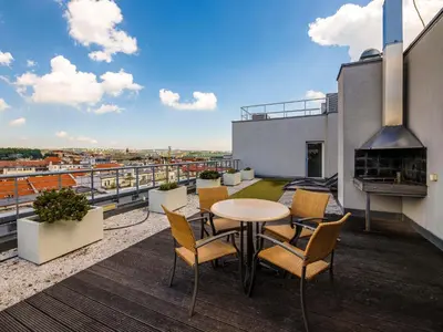 a balcony with a table and chairs and a fireplace at Ibis Praha Old Town in Prague
