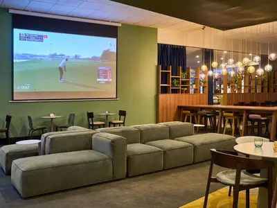 a room with a table with a couch and a chair at Novotel Praha Wenceslas Square in Prague