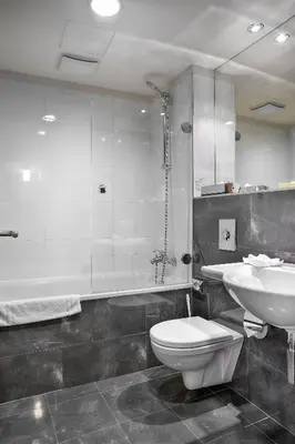 a bathroom with a toilet and a sink and a shower at Majestic Plaza Hotel Prague in Prague