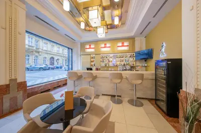 a bar with chairs and a table in a room at Majestic Plaza Hotel Prague in Prague