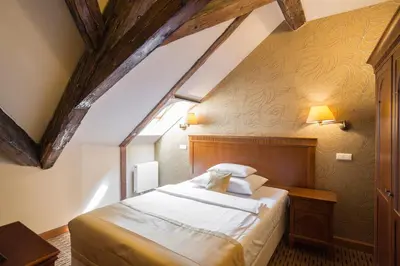 a bedroom with a large bed in a attic at Majestic Plaza Hotel Prague in Prague
