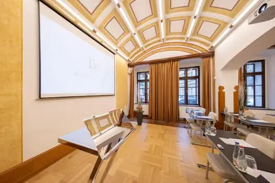 a meeting room with a projection screen in a building at Majestic Plaza Hotel Prague in Prague