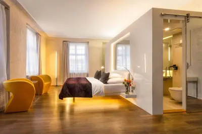a hotel room with a bed and a bathroom at Three Storks in Prague