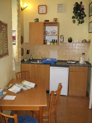 a kitchen with a wooden table and a table and a dining room at Zderaz in Prague