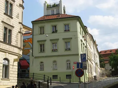 a yellow building with a tower on top of it at Zderaz in Prague