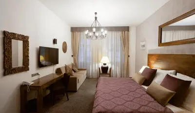 a bedroom with a bed and a living room at Hotel Residence Agnes in Prague