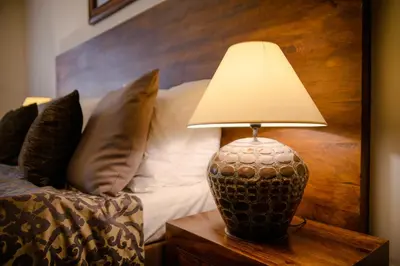 a lamp sitting on a table next to a bed at Hotel Residence Agnes in Prague
