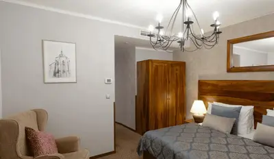 a bedroom with a bed and a chandelier at Hotel Residence Agnes in Prague
