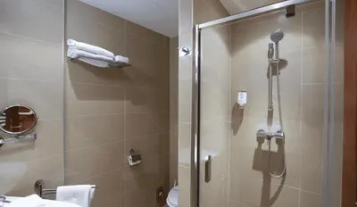 a bathroom with a shower with a glass door at Hotel Residence Agnes in Prague