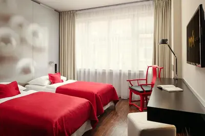 a hotel room with two beds and a window at Perla Hotel in Prague