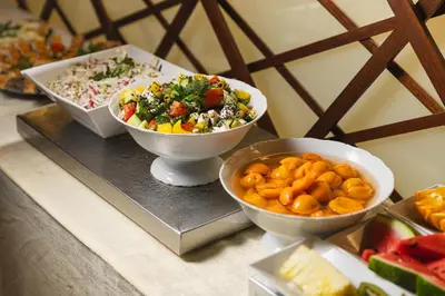a table with three bowls of food on a tray at Perla Hotel in Prague