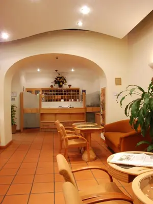 a waiting room with a table and chairs at EA Hotel Tosca in Prague